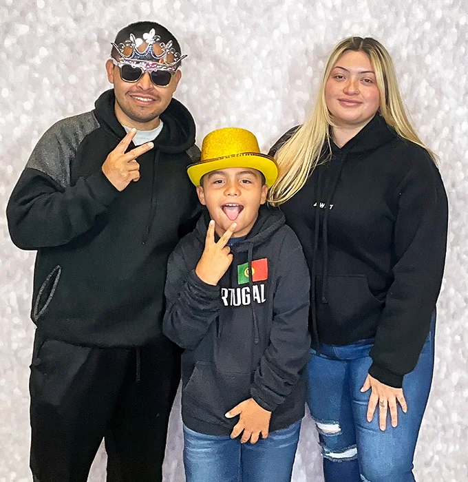 family smiling together at photo booth event in Carson California