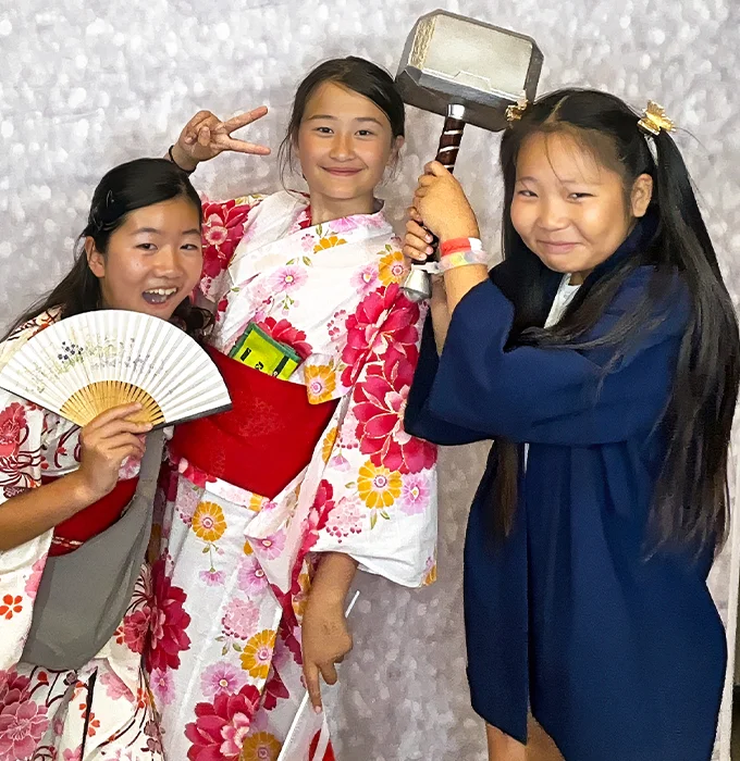 girls wearing traditional outfits posing at photo booth in Carson California