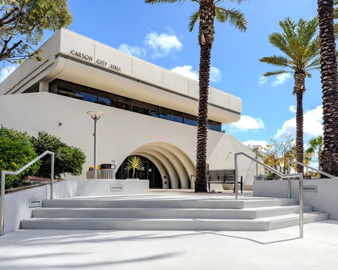 Exterior view of Carson City Hall building with palm trees on a sunny day in Carson California located in Los Angeles County