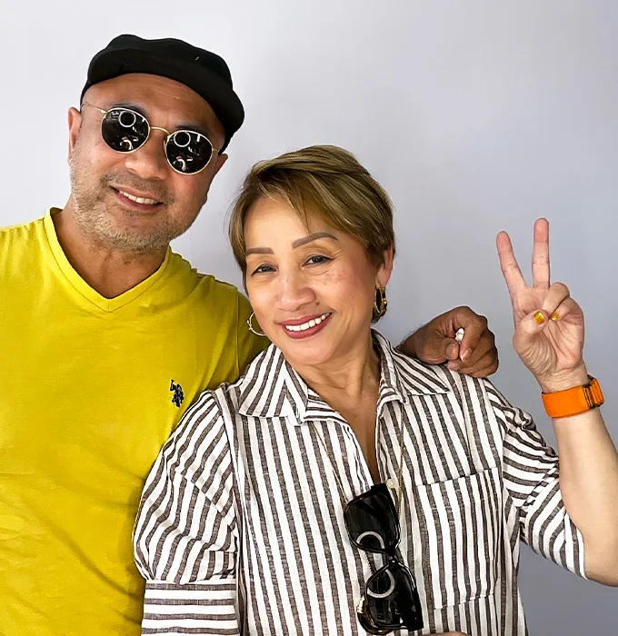 couple smiling and making peace sign at photo booth in Carson California
