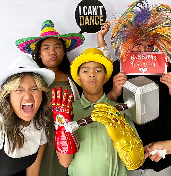 kids making funny faces wearing photo booth props in Carson California