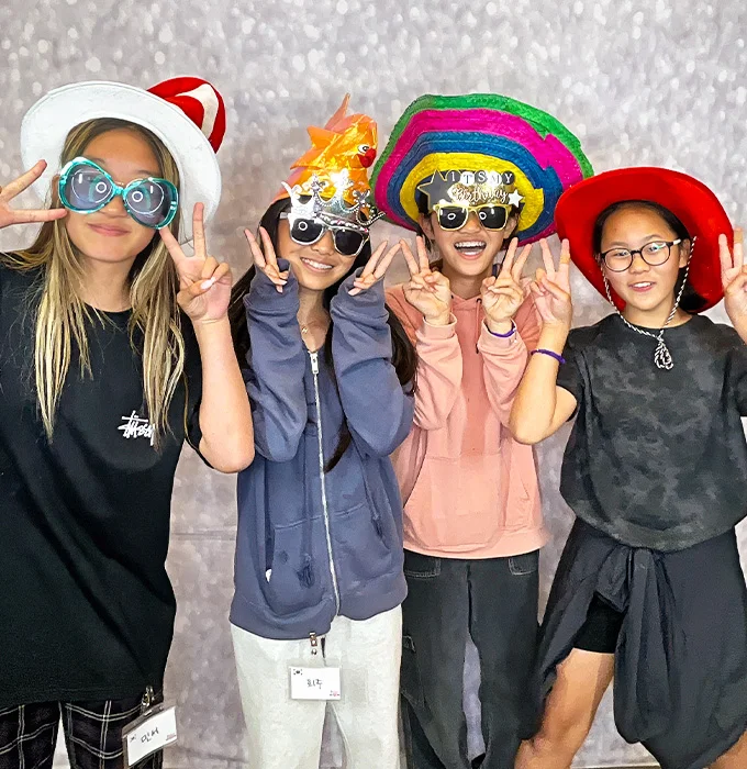 kids wearing funny hats and glasses at photo booth party in Carson California